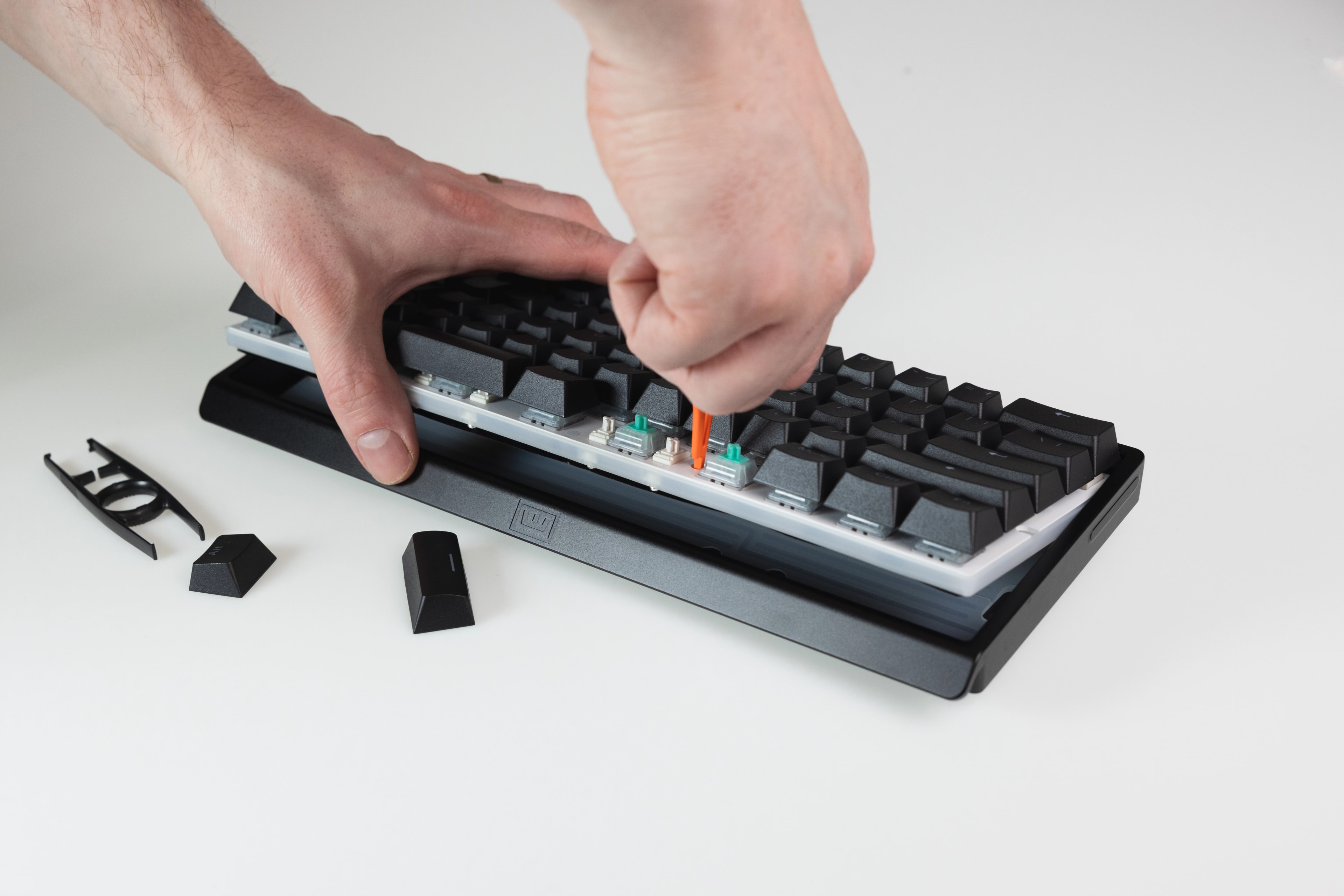 Wooting 60HE v2 showing the pulling of the PCBA out of the case